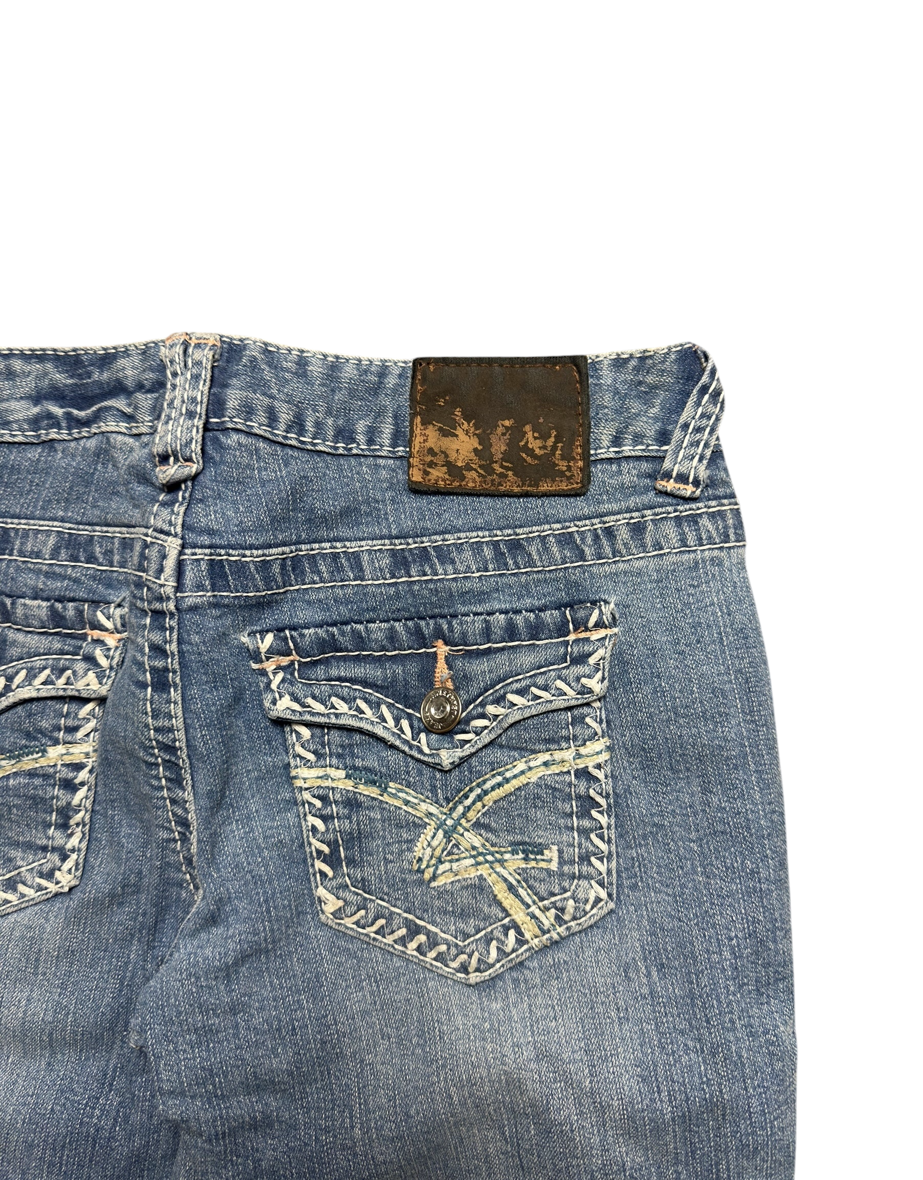 NinetyThree medium-wash bootcut jeans featuring back pockets with intricate contrast stitching and embroidery.