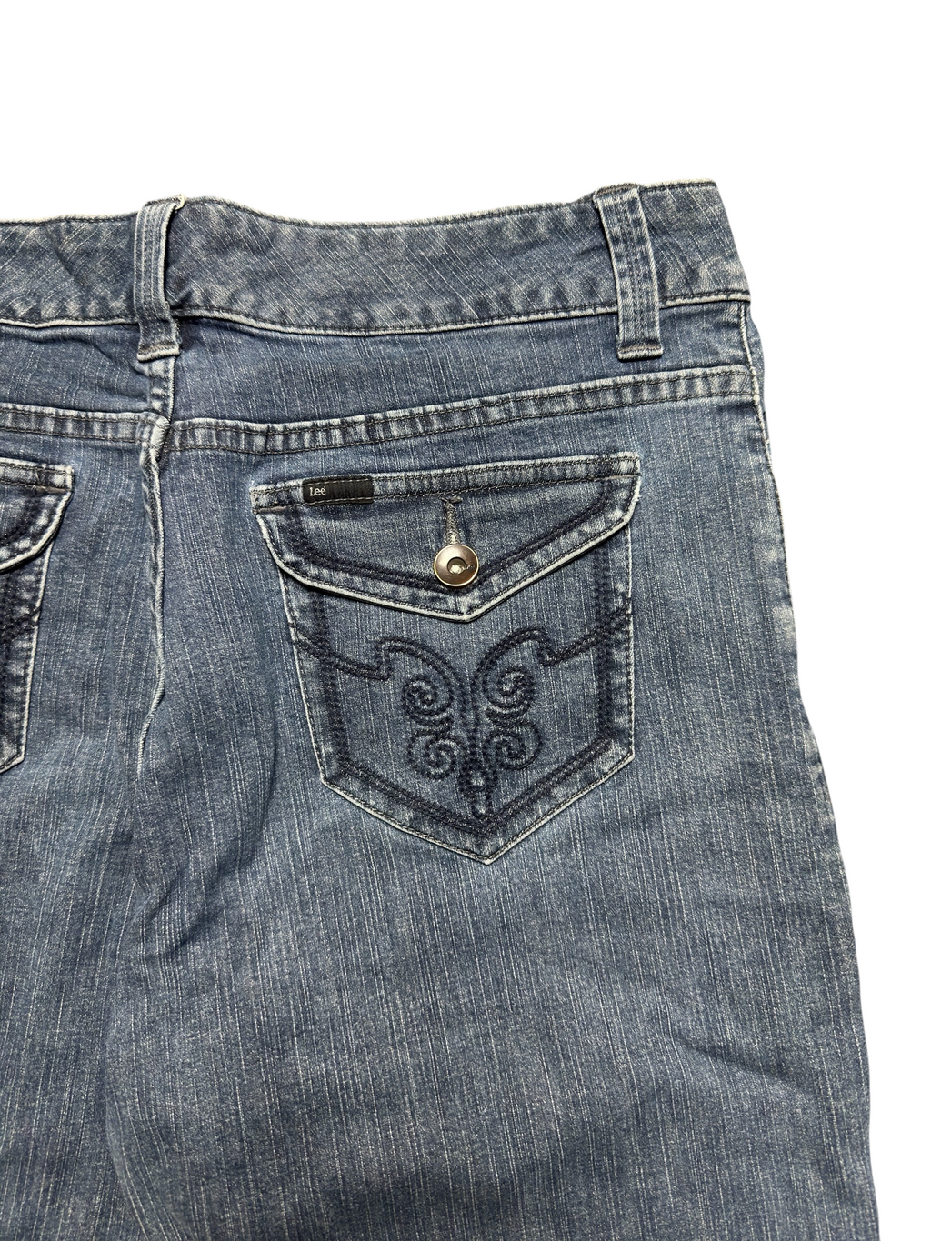 NinetyThree Lee Slender Secret medium blue denim jeans featuring back pockets with intricate embroidery and button flaps