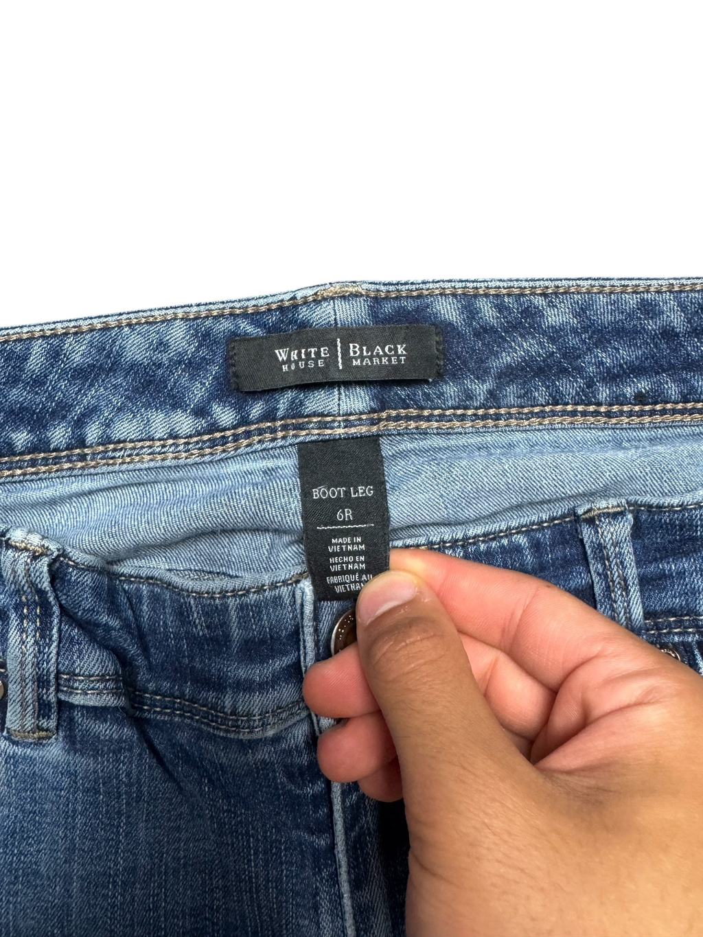 NinetyThree White House Black Market medium-wash blue denim boot leg jeans with interior brand label and size tag